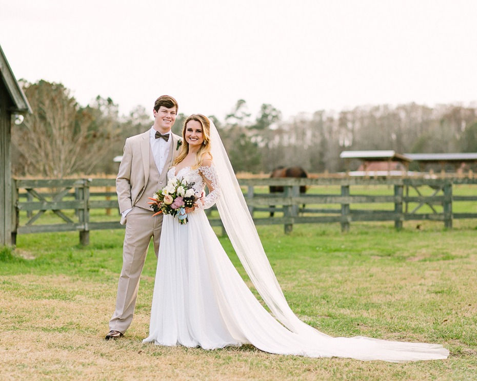 Bride and groom pose on their wedding day outdoors