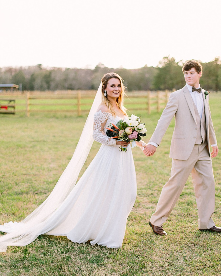 Bride and groom holding hands on their wedding day