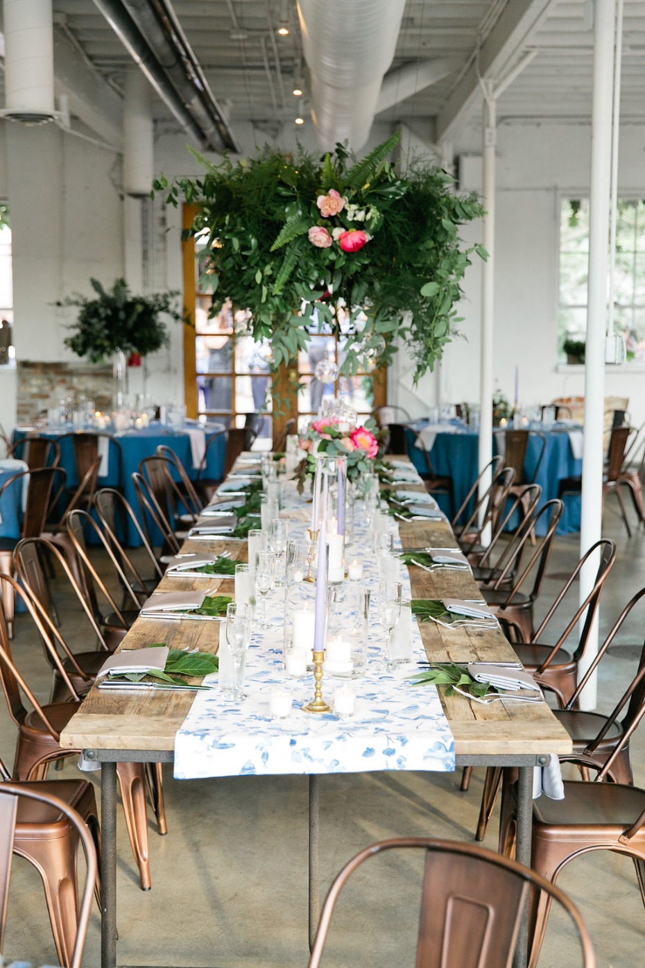 industrial chic head table idea with floral chandelier