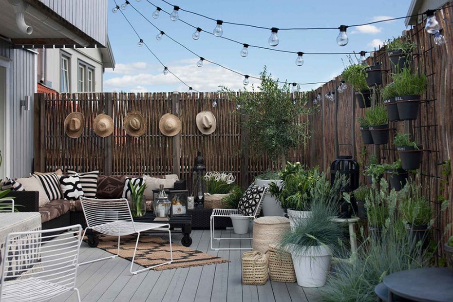 Stylish patio with lights, plants, and outdoor furniture