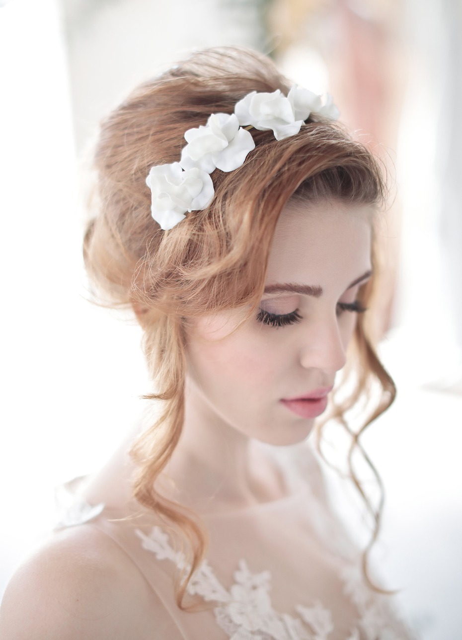 Elegant bride with floral headband, wedding hairstyle and dress