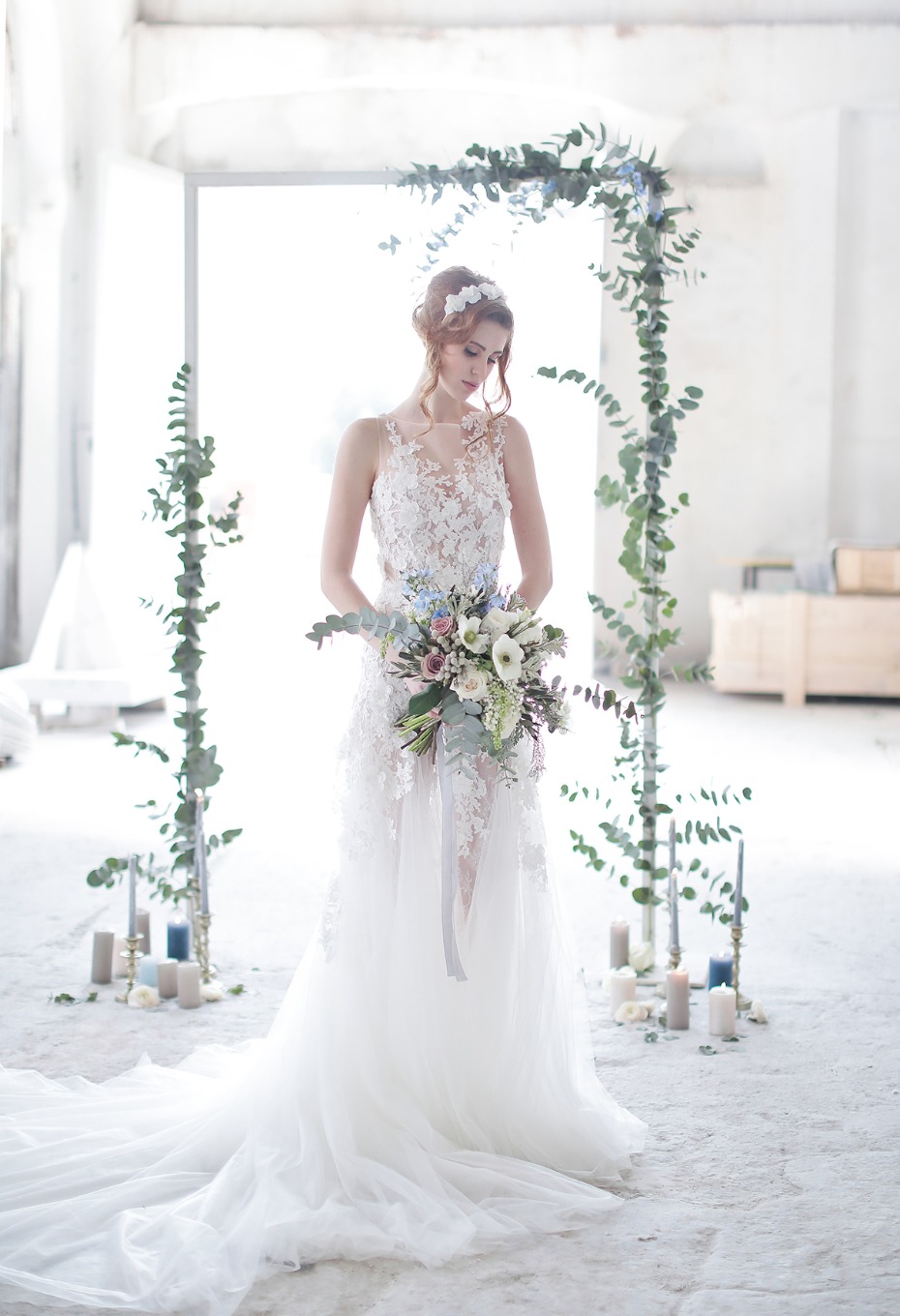 Elegant bride in a white dress with floral bouquet, ready for wedding