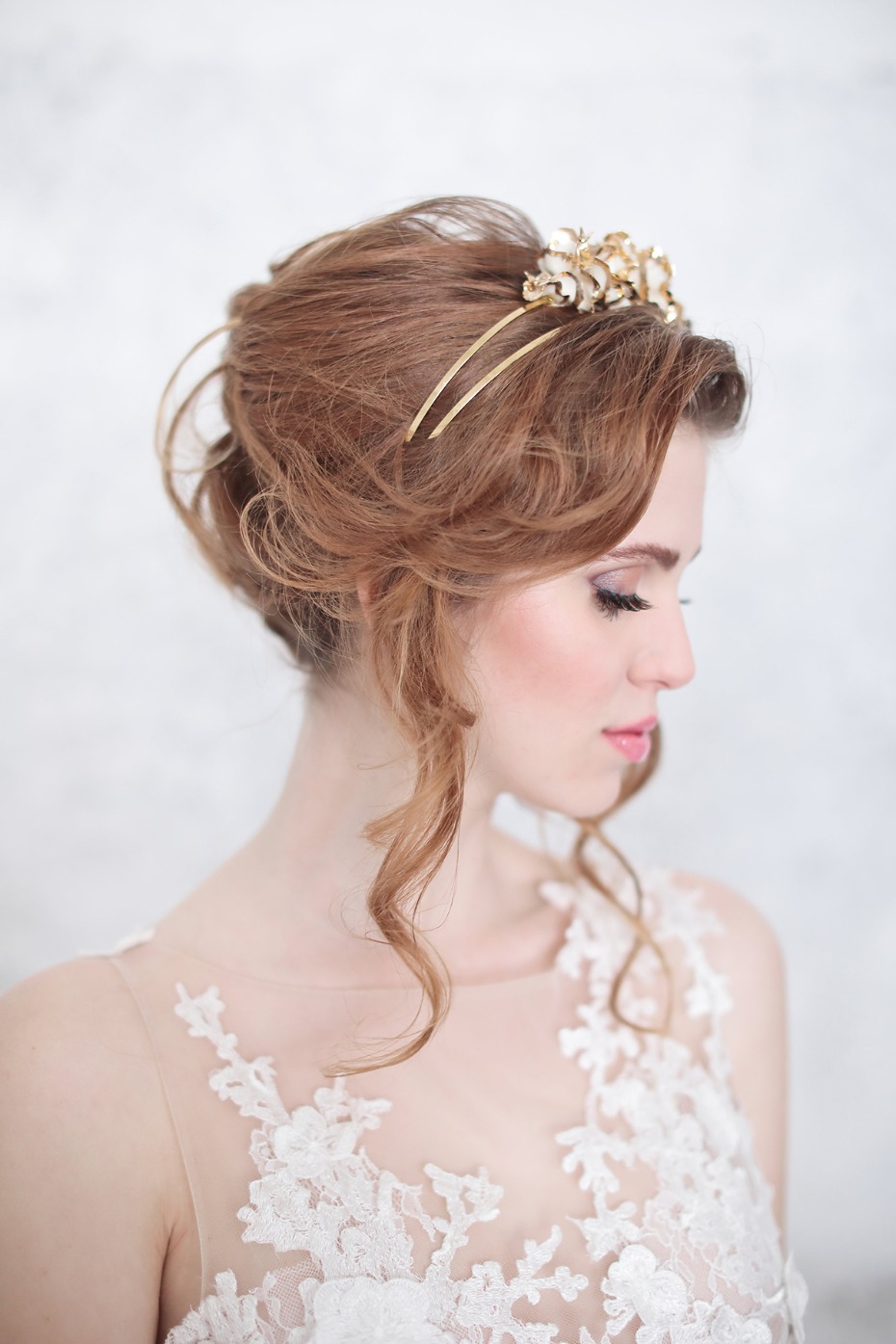 Bride with floral hairpiece and lace wedding dress