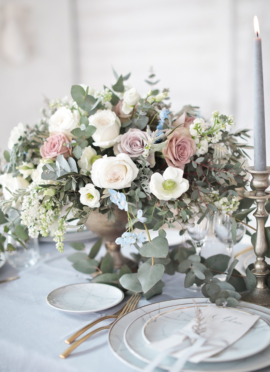 Elegant floral centerpiece on a beautifully set table with soft hues