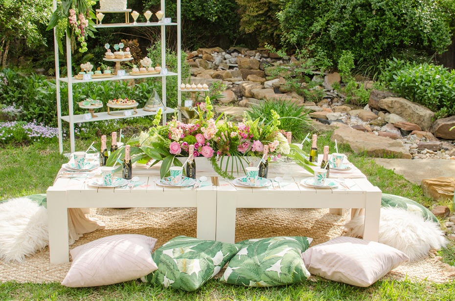 floor level party table with pink and green tropical decor