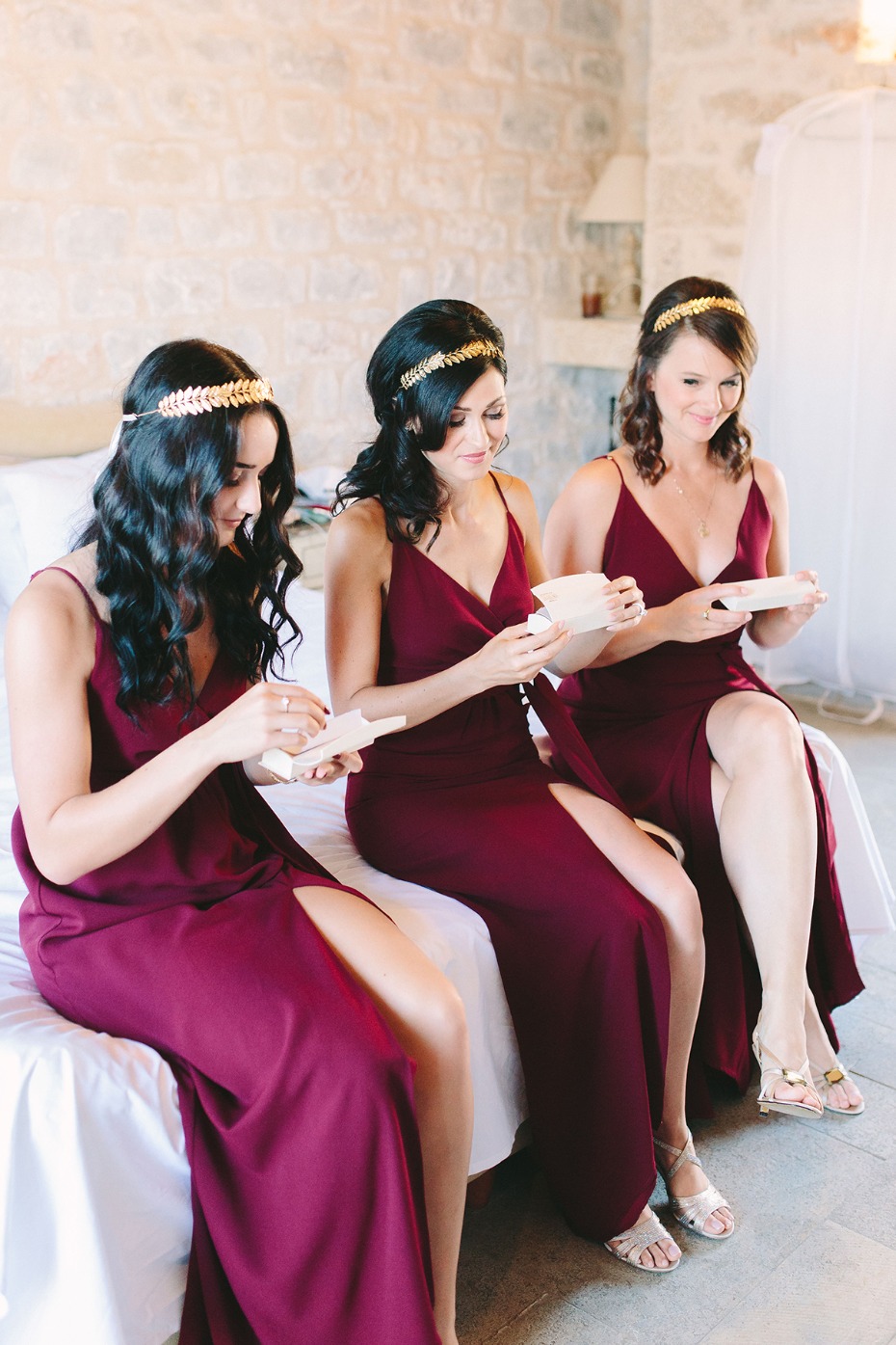 bridesmaids in golden halos and deep red dresses