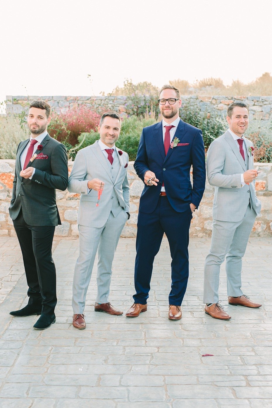 groom and his groomsmen in assorted grey suits