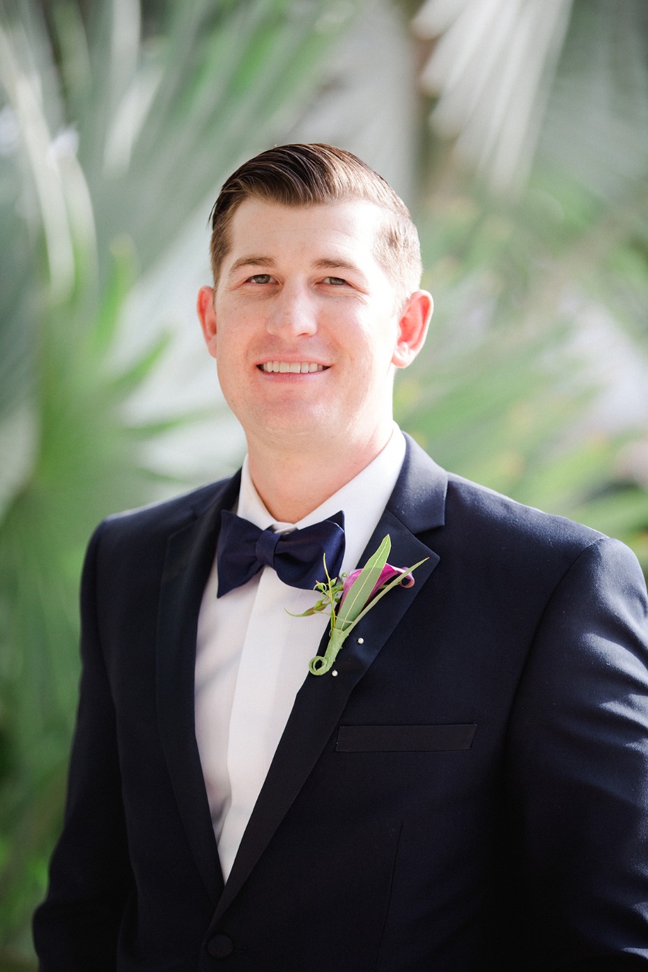 groom in classic suit and bow tie