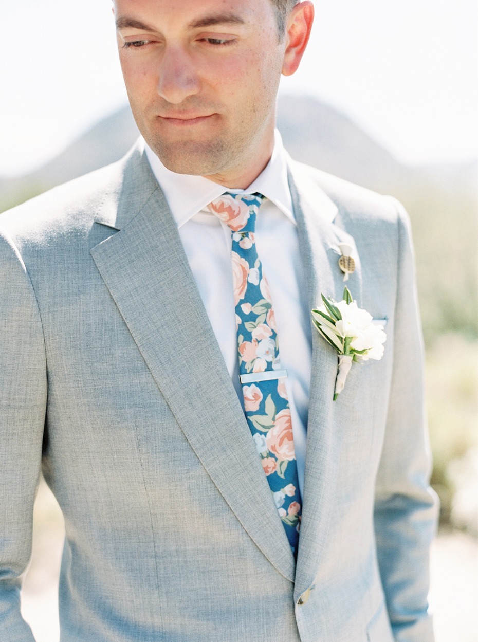 groom in heather grey suit and floral print tie