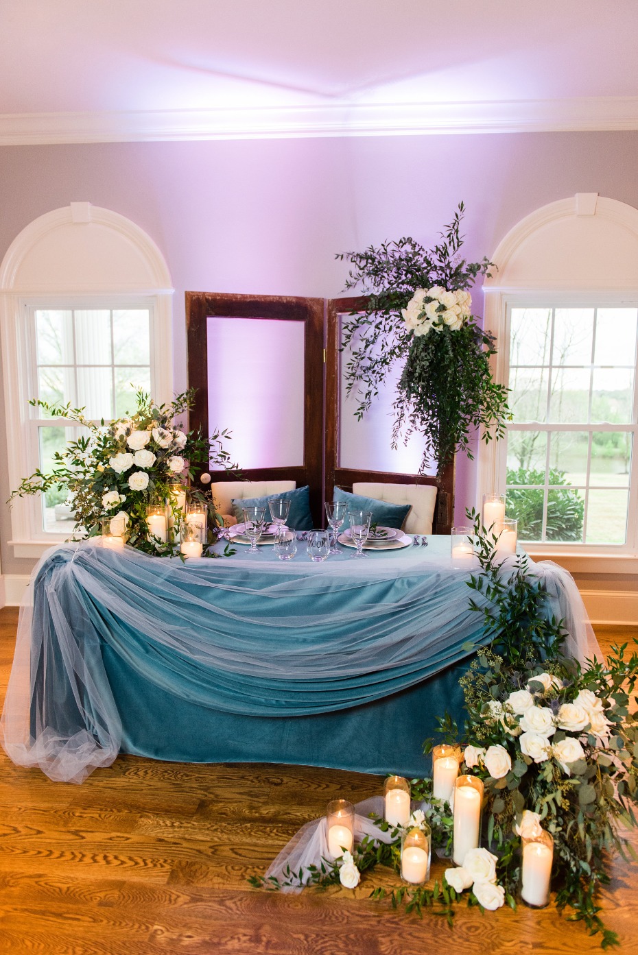 sweetheart table in blue velvet and cascading florals