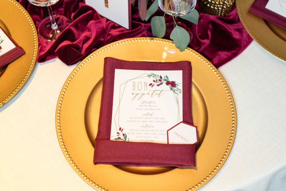 gold and burgundy table place setting