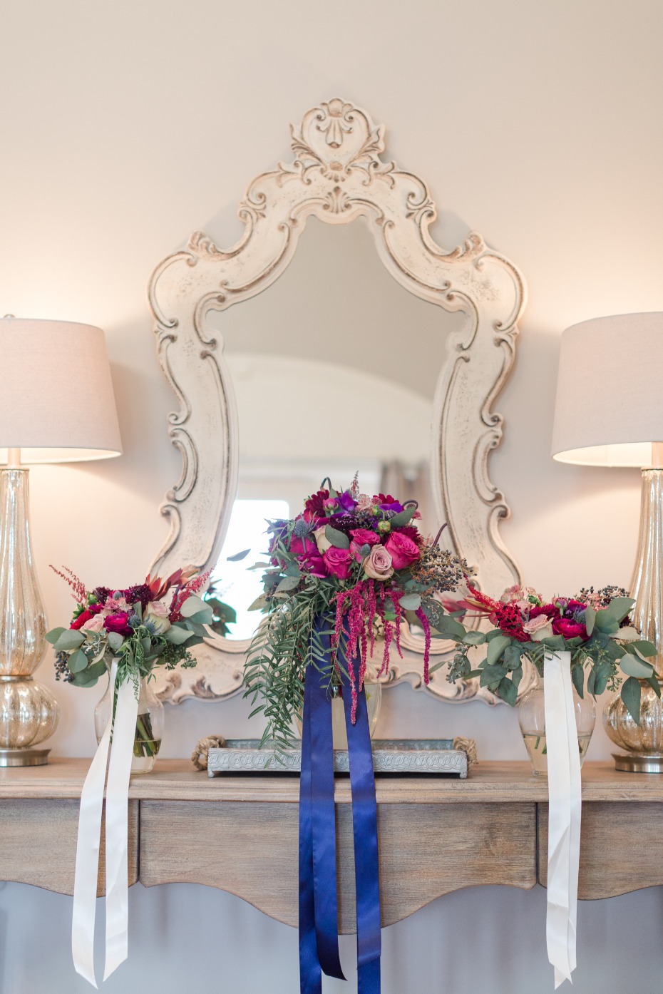 Elegant wedding bouquets displayed on ornate mirror