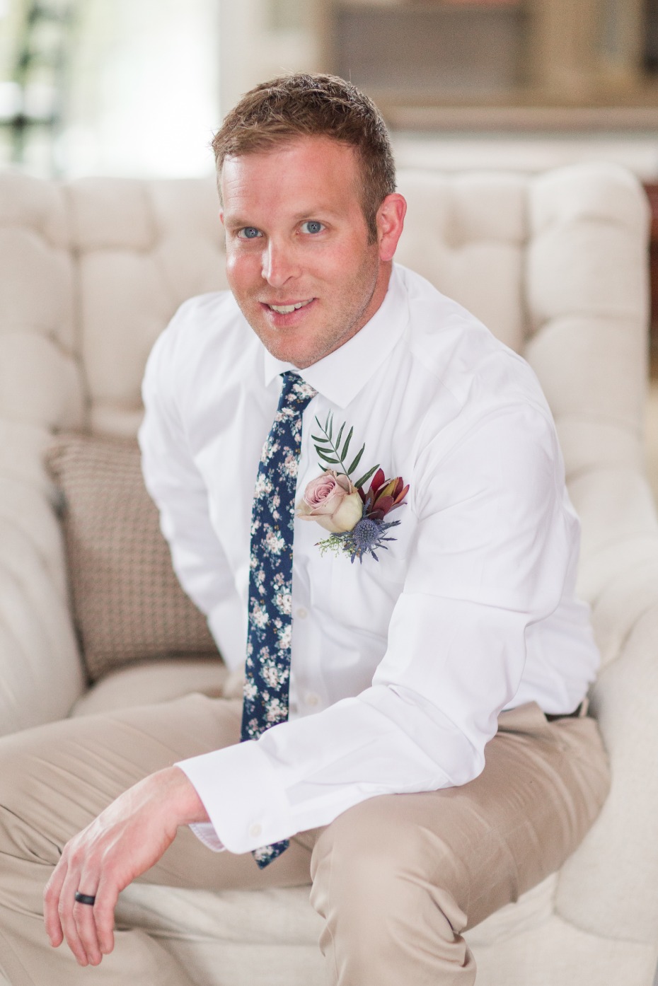 Smiling groom in white shirt and floral tie