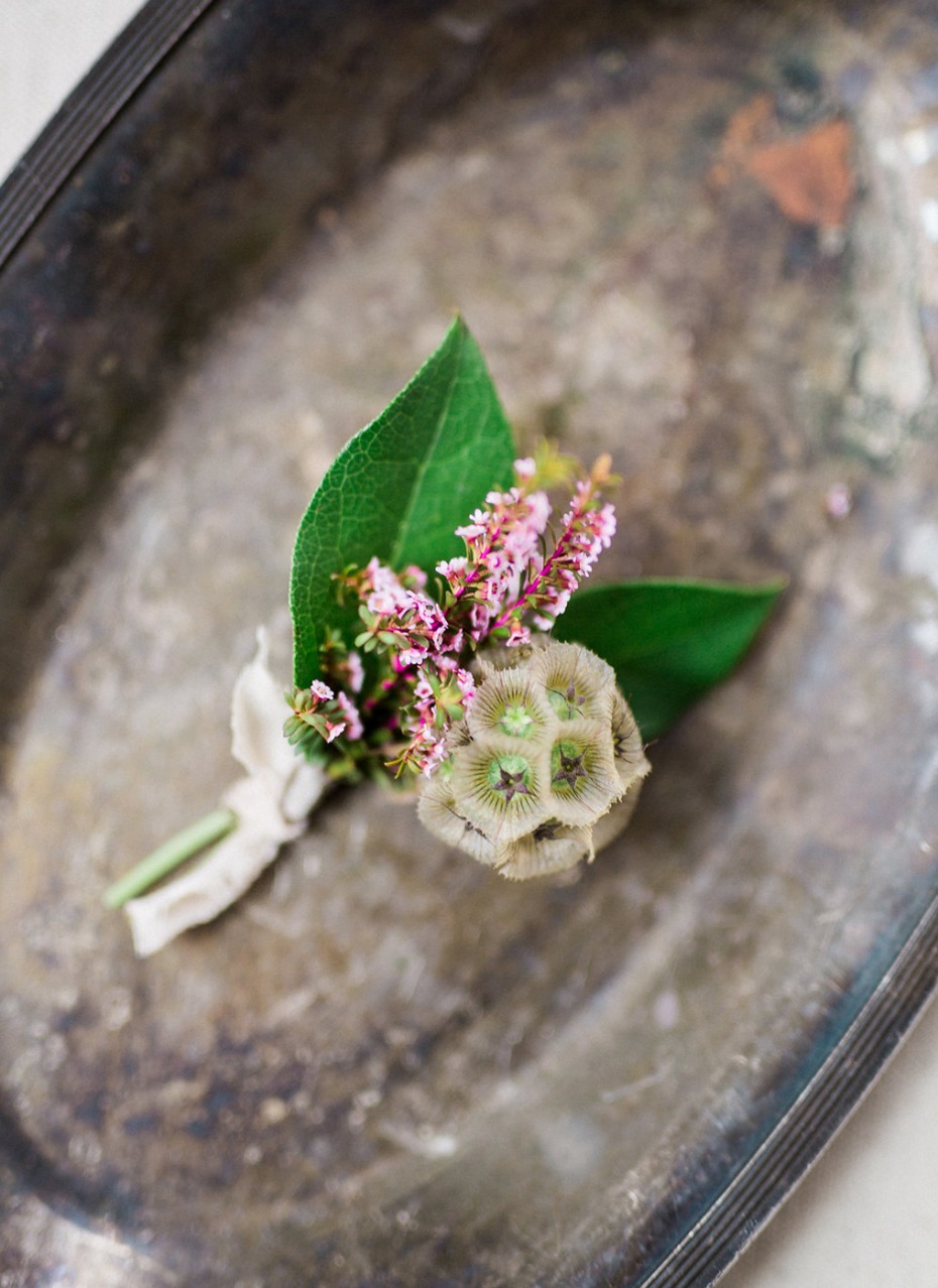 Rustic boutonniere with pink flowers and lotus seed pod