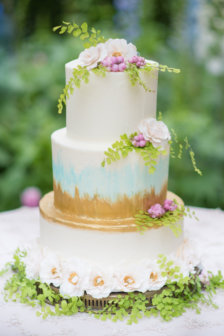 painted wedding cake in gold and teal
