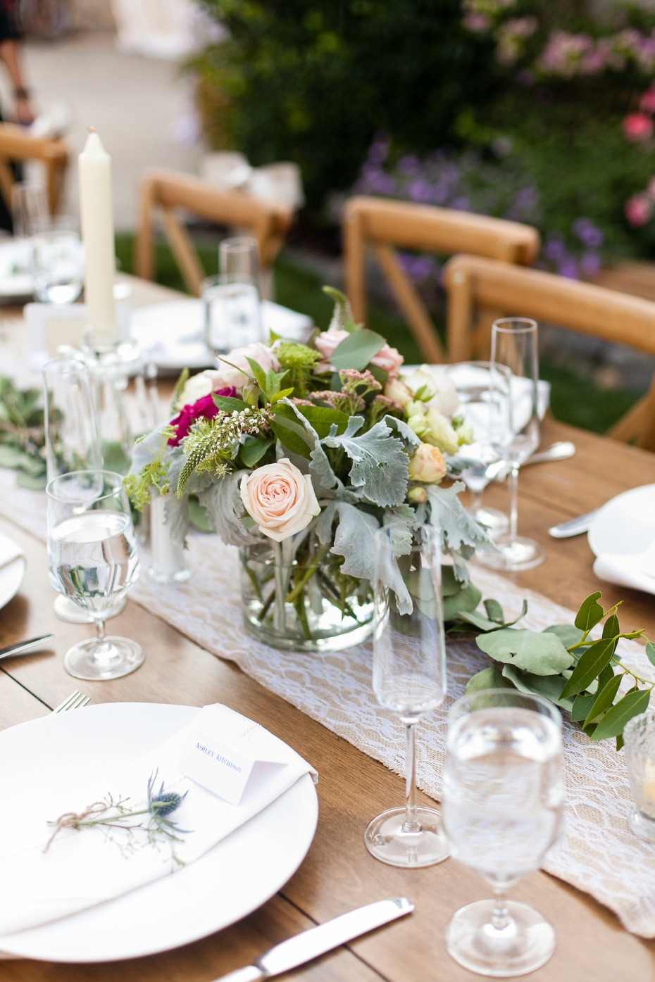 Rustic wooden wedding table setting with floral centerpiece