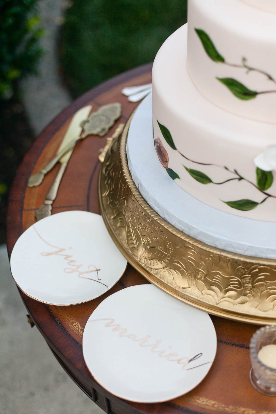 Elegant wedding cake with floral details and plates