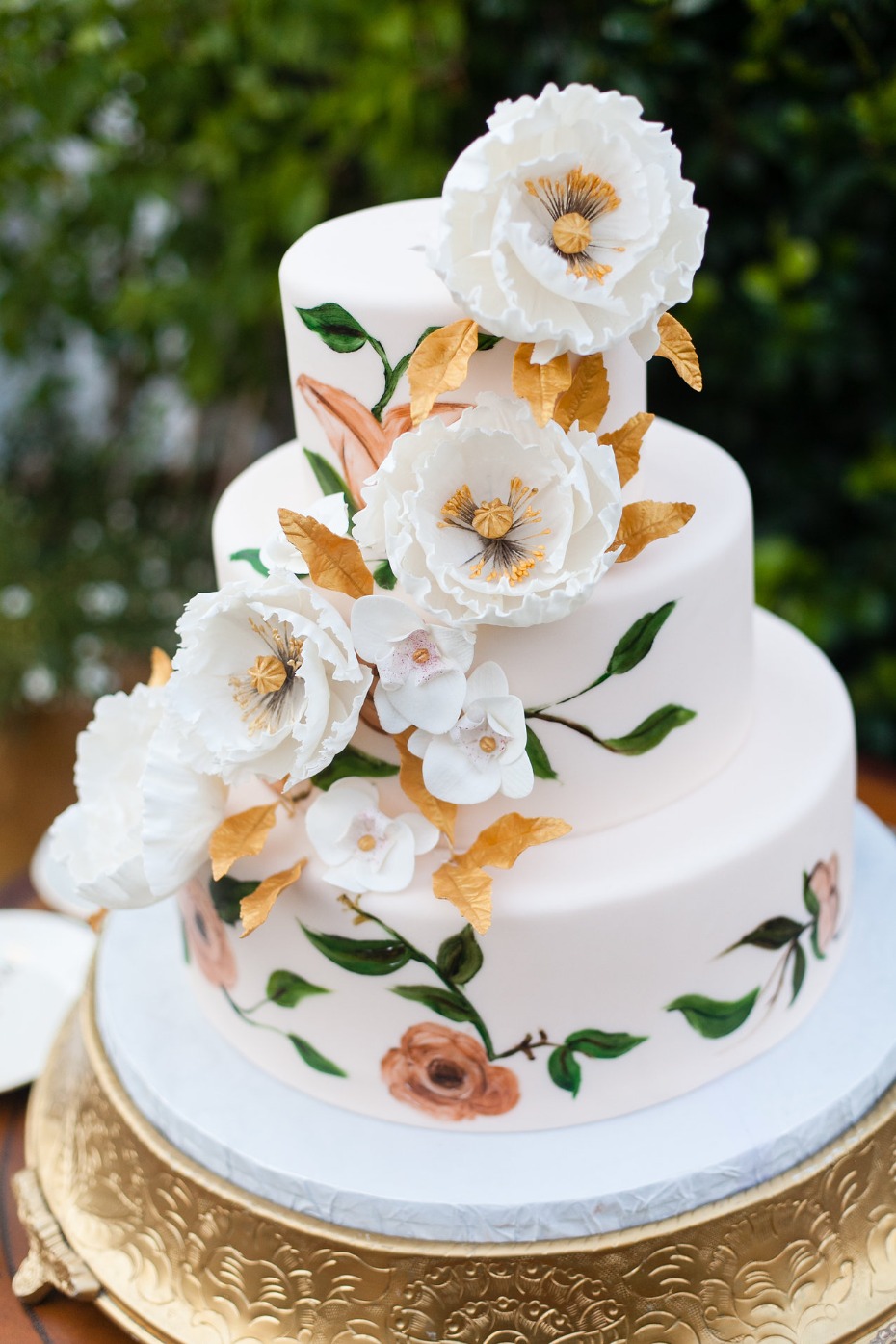 Elegant three-tiered wedding cake with floral design