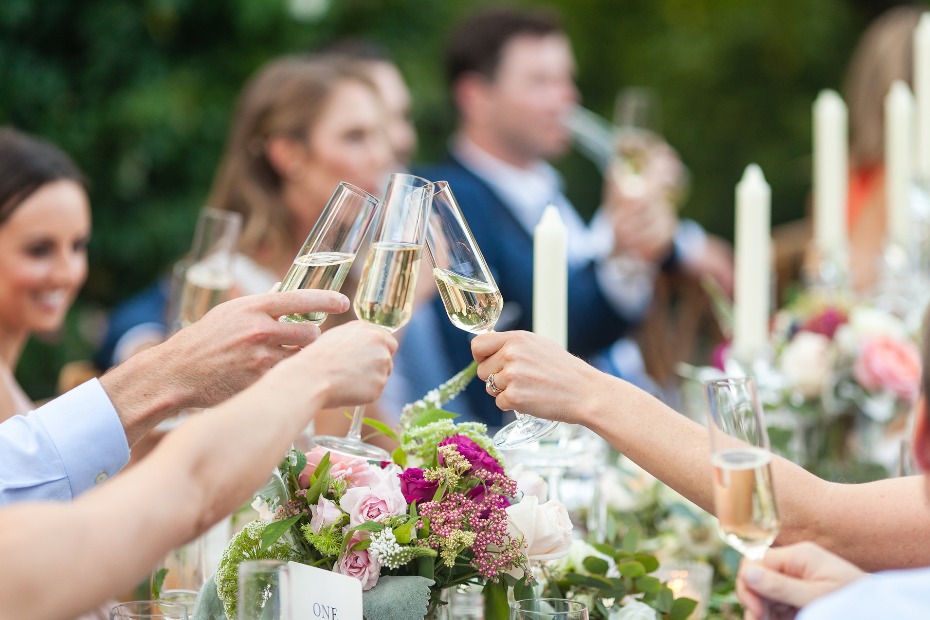 Wedding guests toasting with champagne flutes