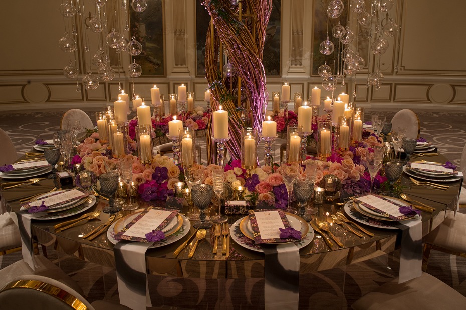 candle lit wedding table with pink and purple glam decor