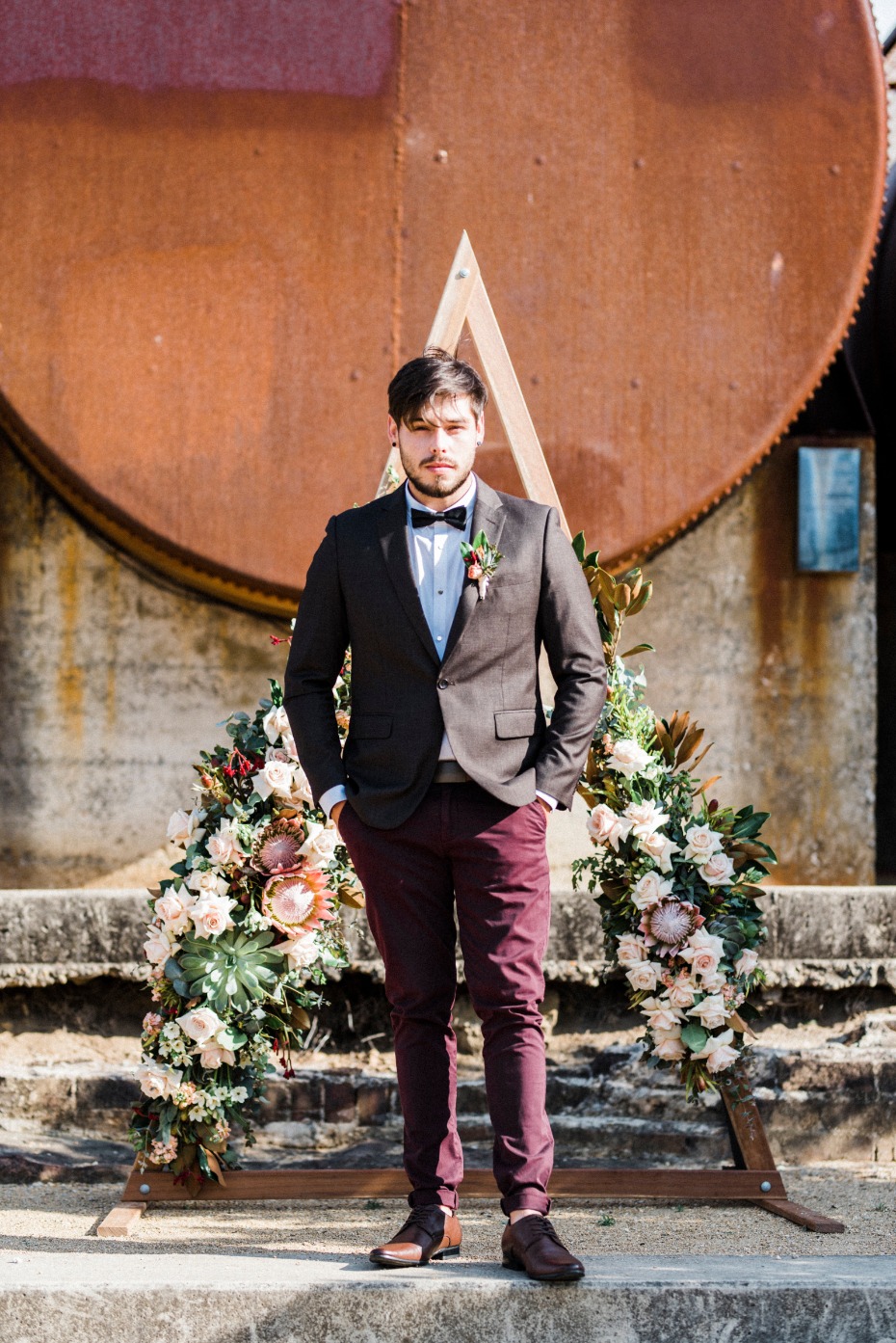 Mix and match groom look with burgundy pants