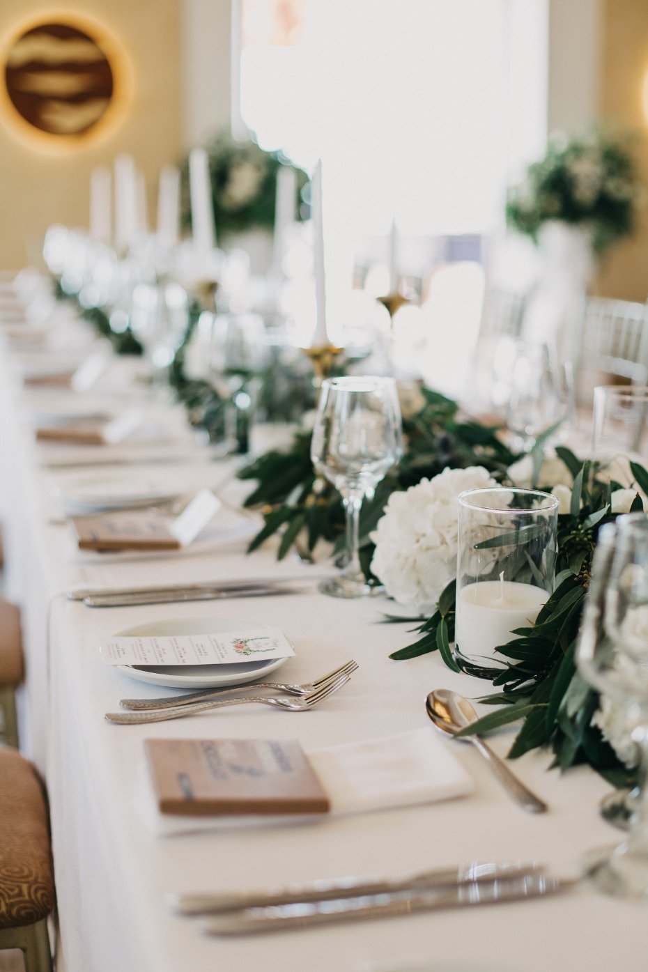 Reception table with greenery and white flowers