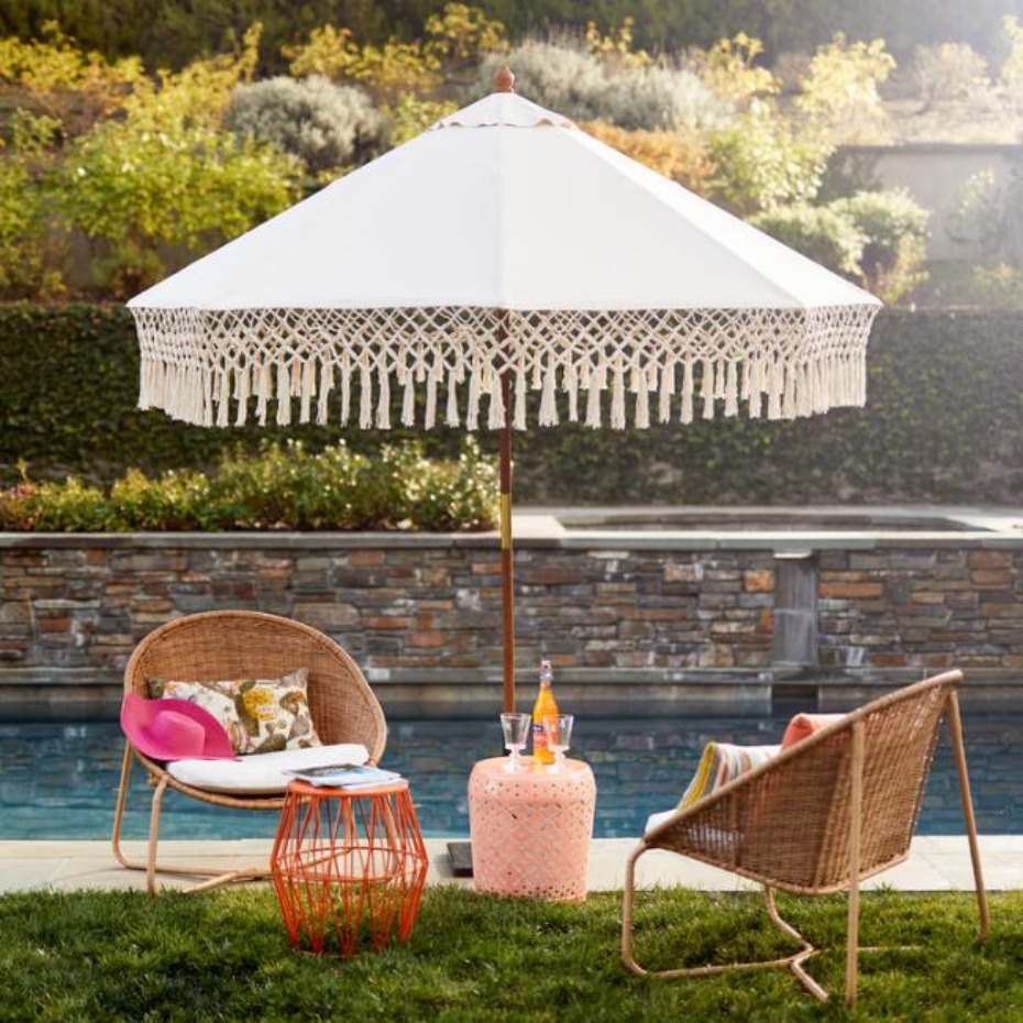 Poolside lounge area with umbrella and rattan chairs