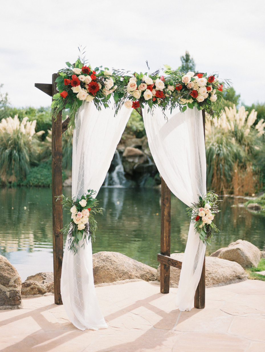 Red and blush ceremony arbor
