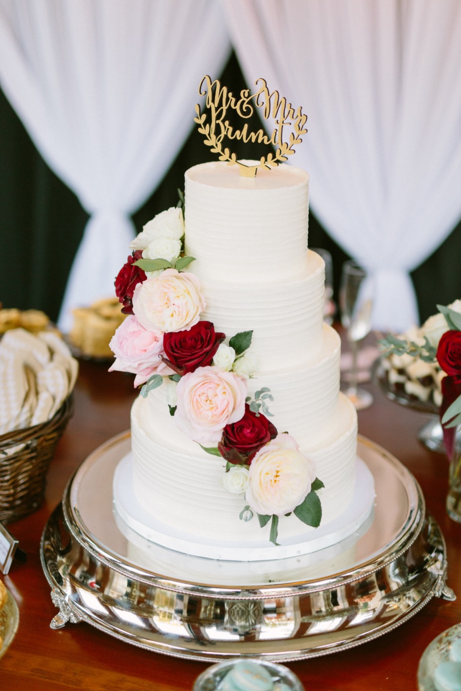 White wedding cake with cascading roses