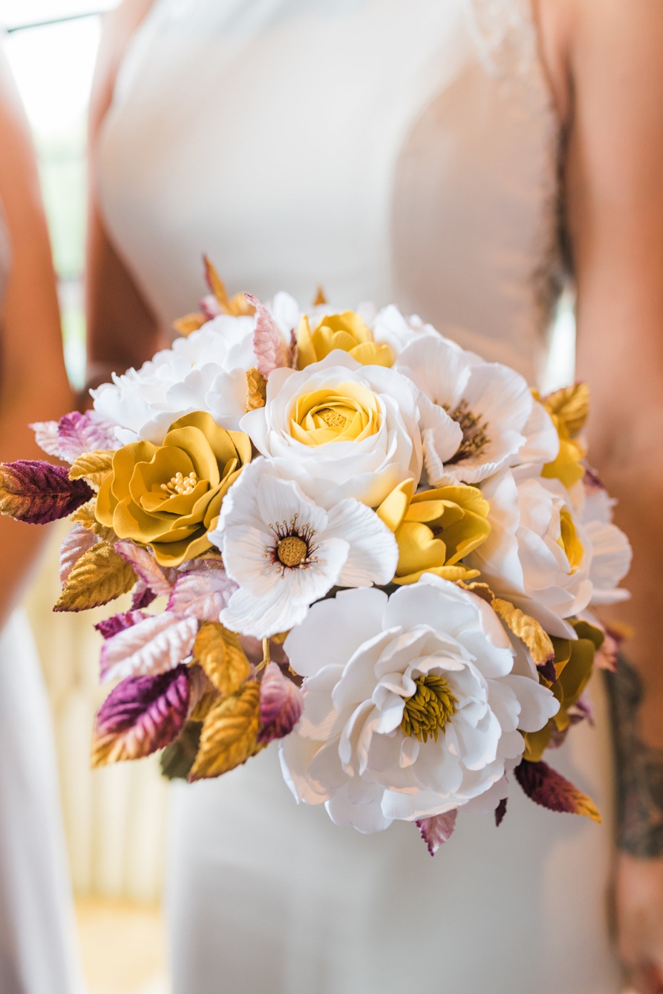 wedding bouquet in gold white and purple
