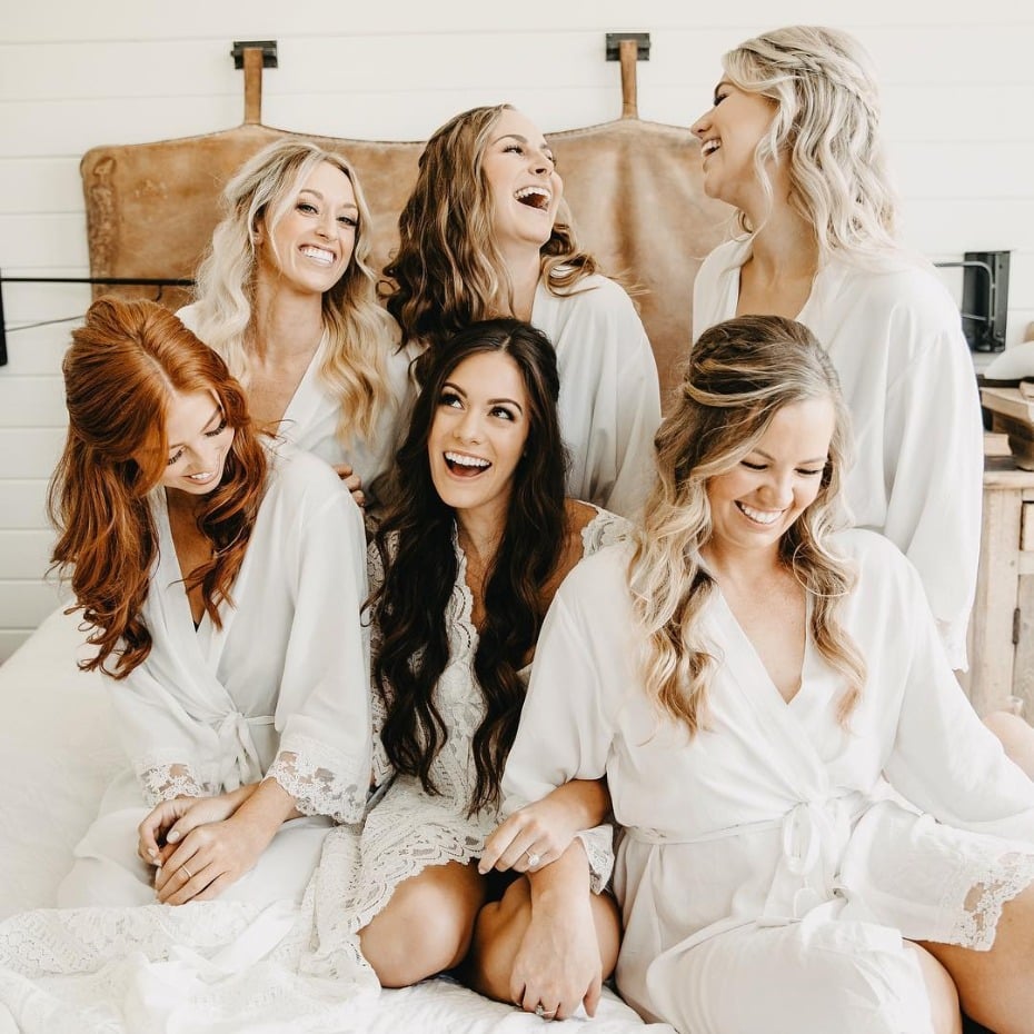 Happy bridesmaids lounging in bed