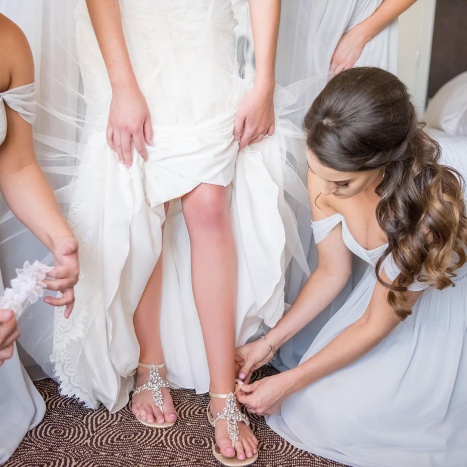 Putting on the bride's shoes and garter