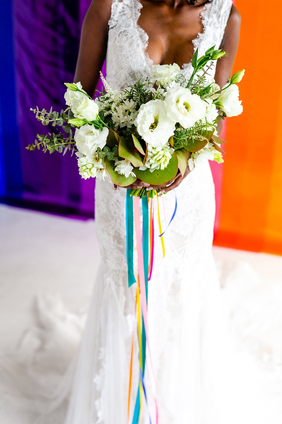all white wedding bouquet with rainbow bouquet ribbons