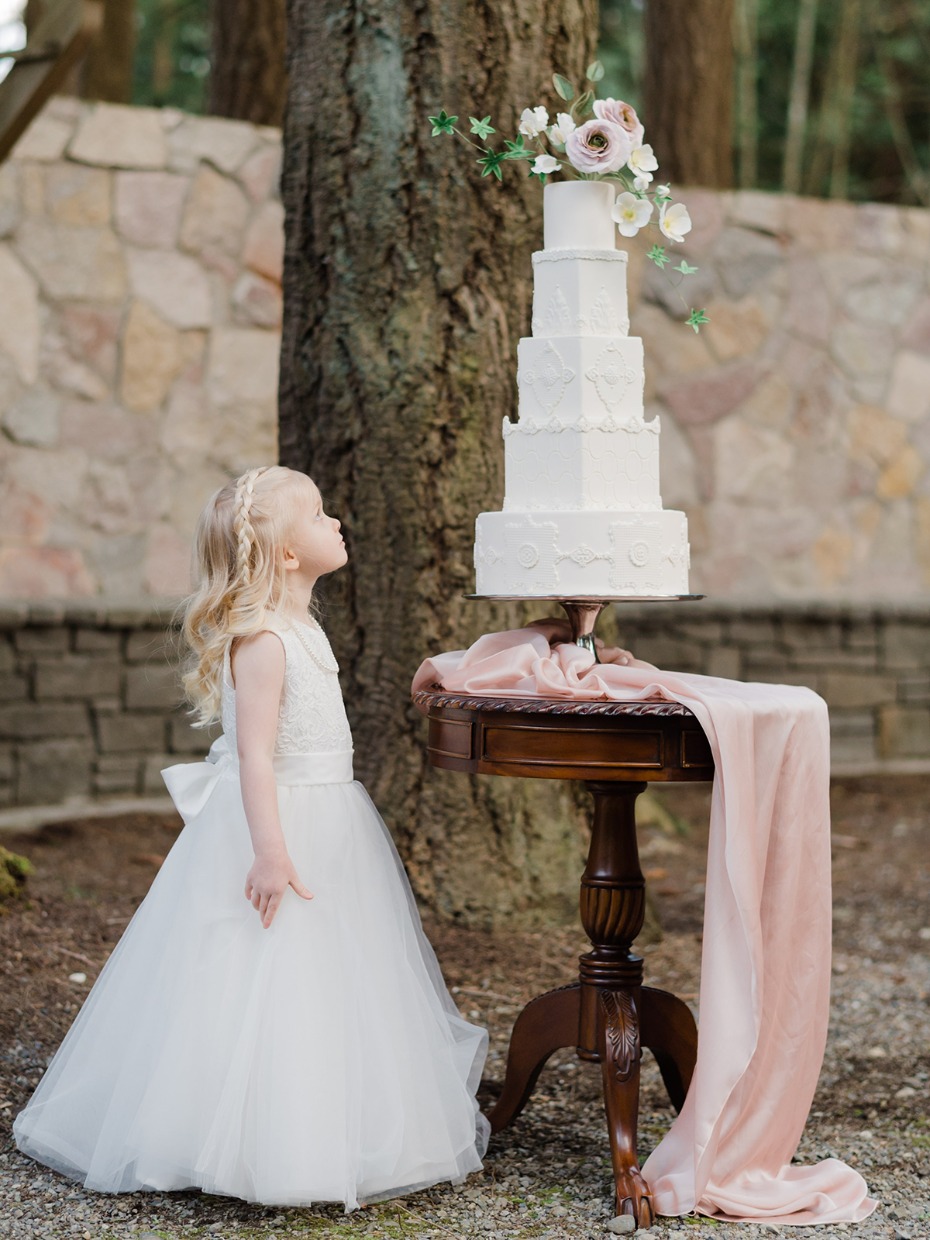 sweet little flower girl and wedding cake