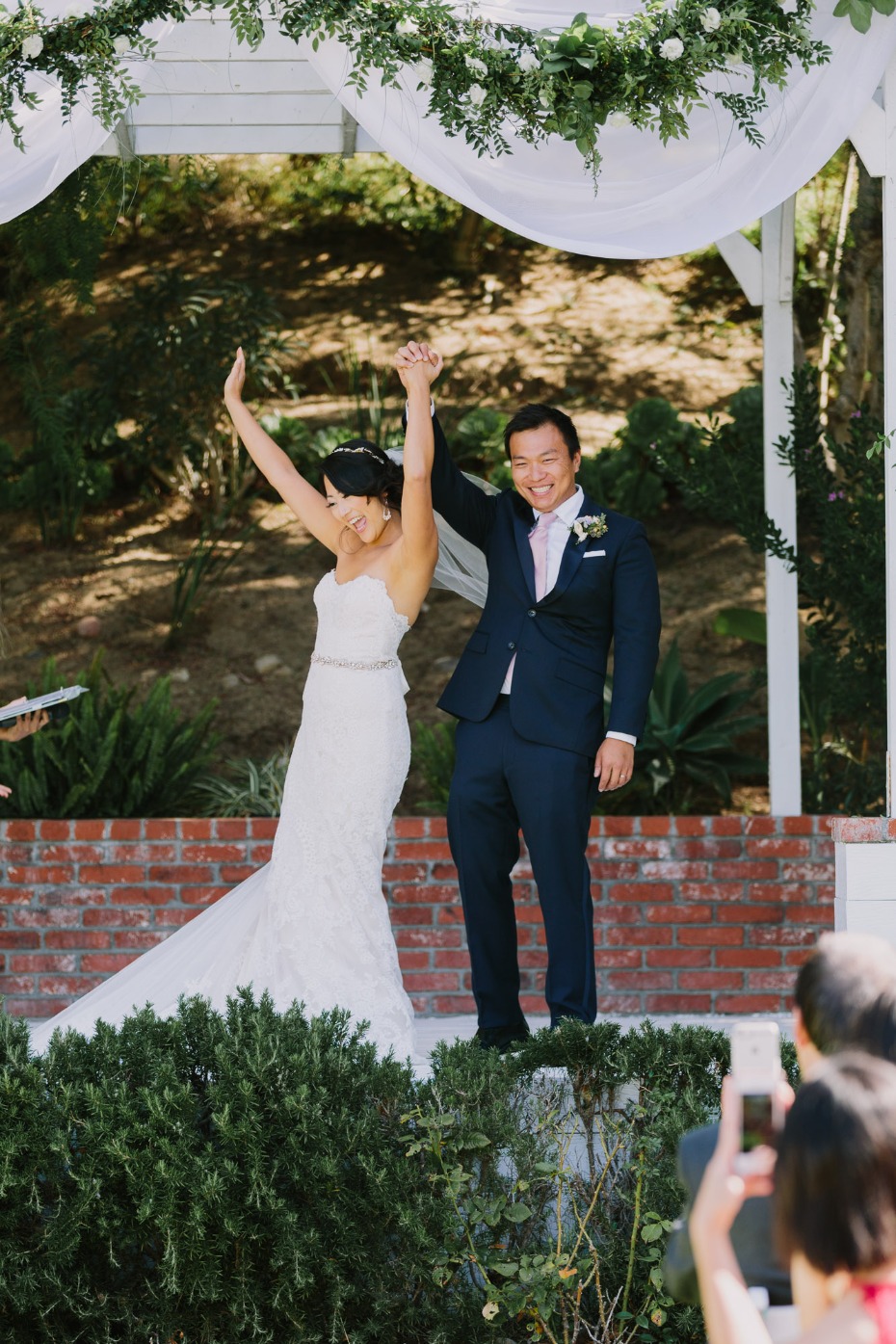 Newly married couple joyfully celebrate their wedding day outdoors