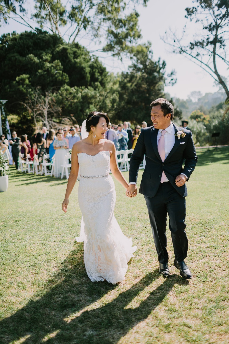 Happy newlyweds walking down the aisle after the wedding ceremony