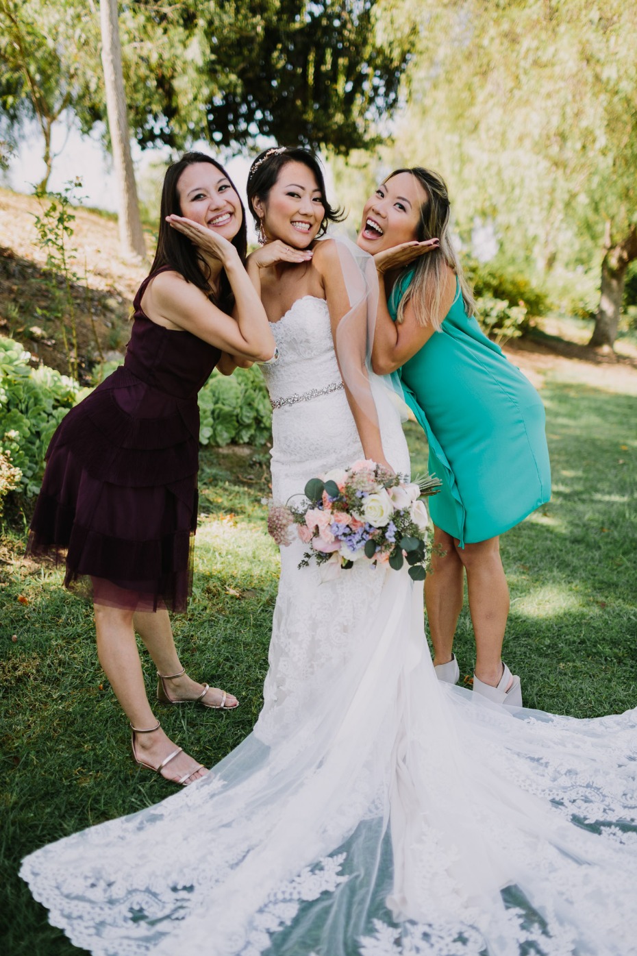 Bride posing with bridesmaids on her wedding day, smiling