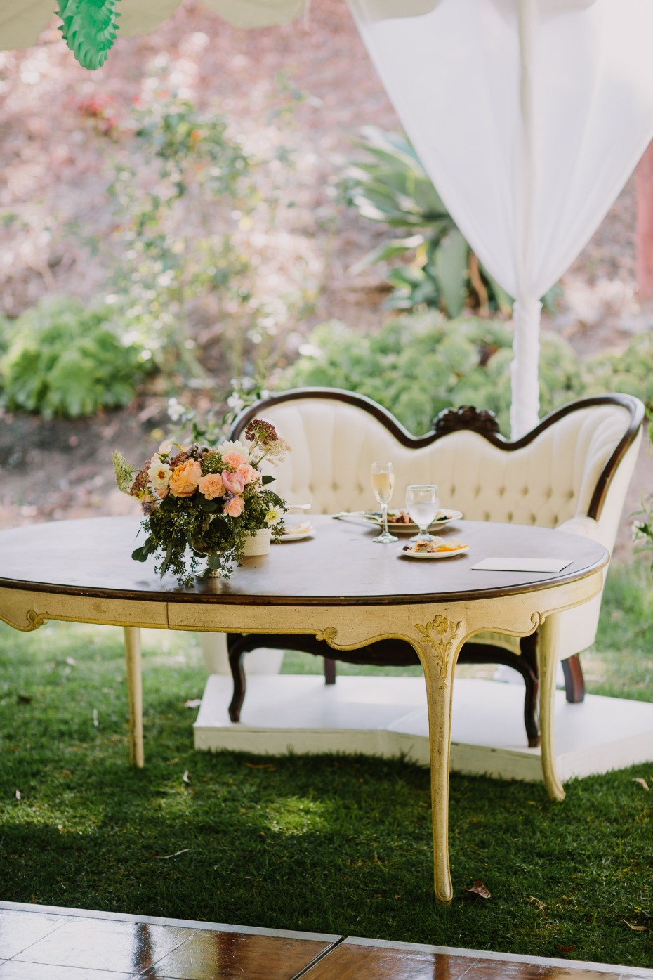 Elegant wedding table with floral centerpiece and classic sofa