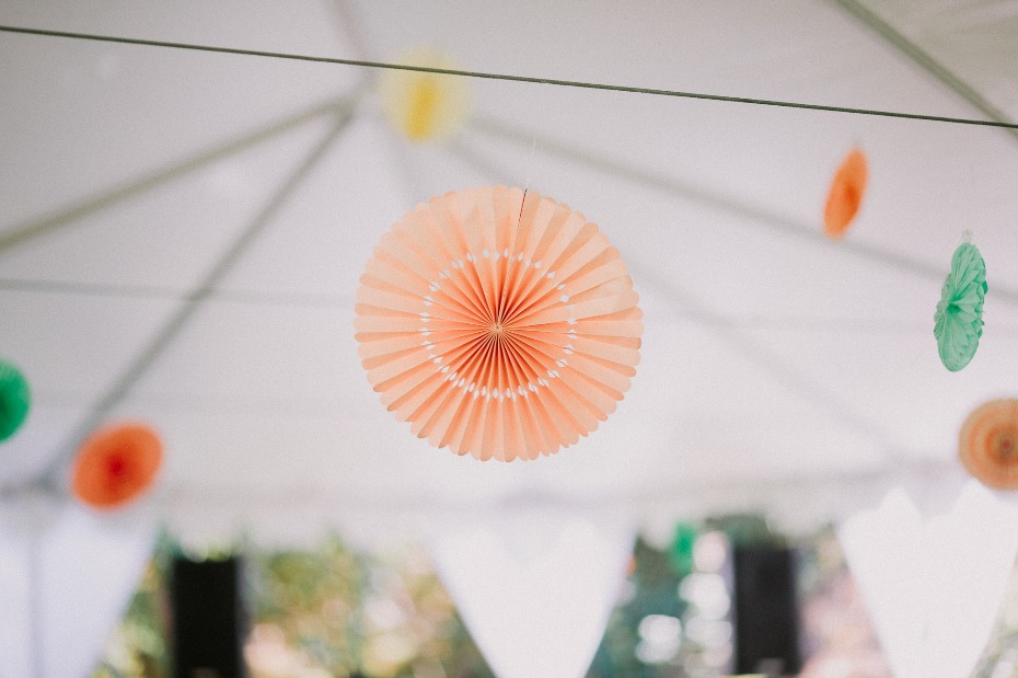 Colorful paper fan decorations hanging at an outdoor event