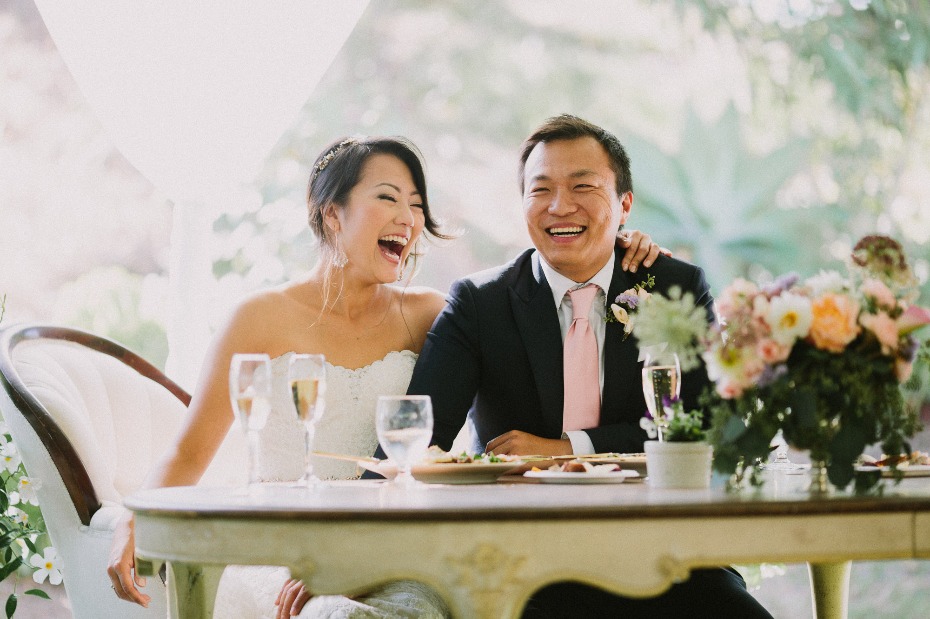 Bride and groom laughing together during their wedding reception