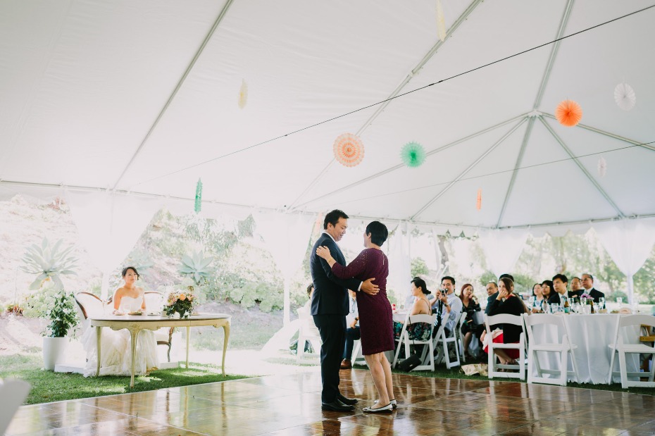 Couple dancing under a tent at a wedding reception