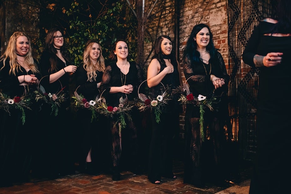 bridesmaids in black with hoop bouquets