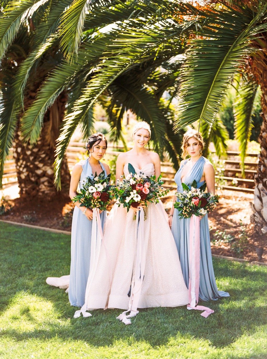 Blush wedding dress and blue bridesmaid dresses