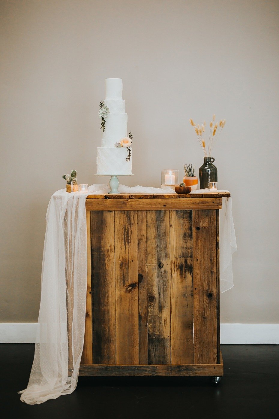 Rustic cake stand with potted cacti