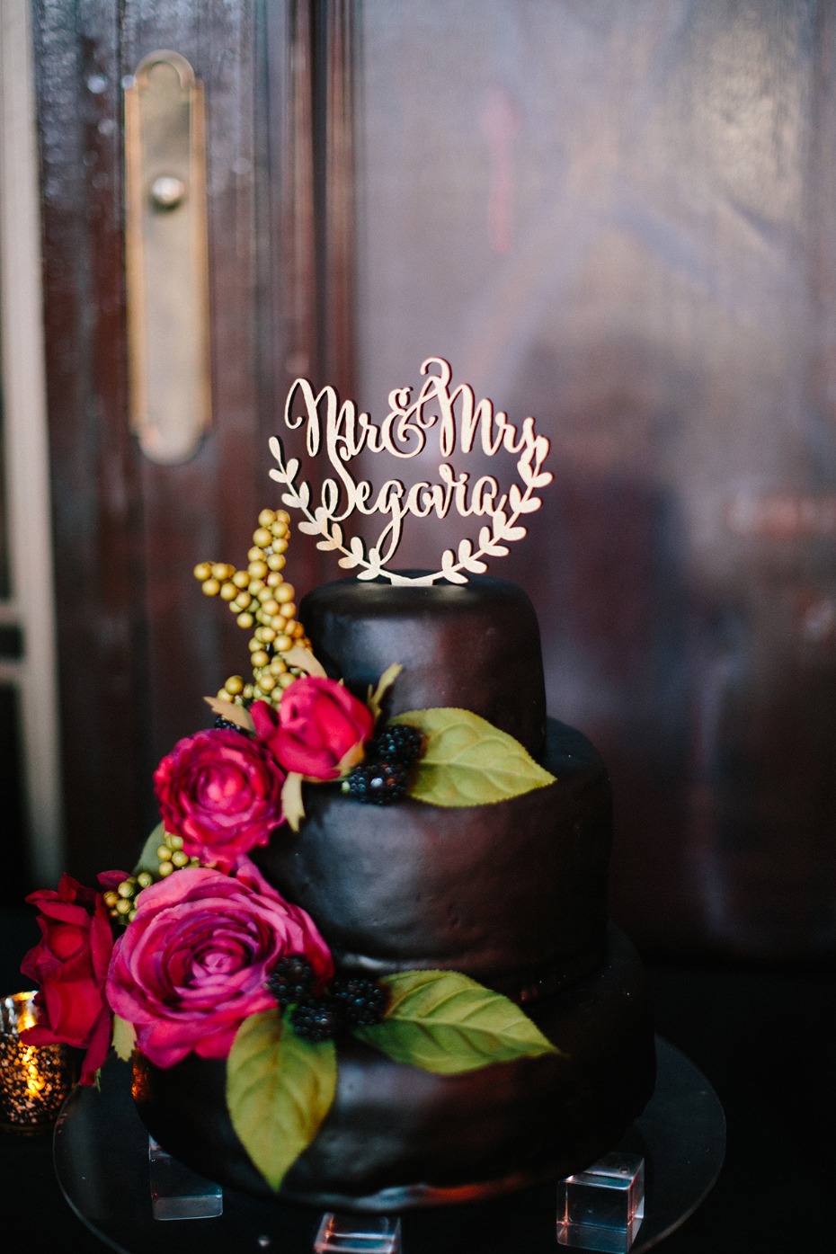 Black wedding cake with pink and red florals