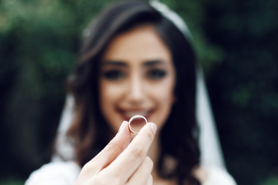 Bride Holding a Ring Photo by Soroush Karimi