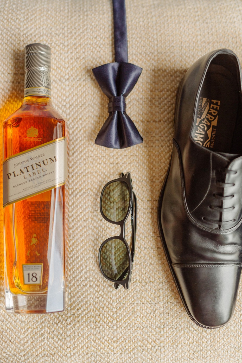 Whiskey, bow tie, shoes, and sunglasses, the essentials for a groom