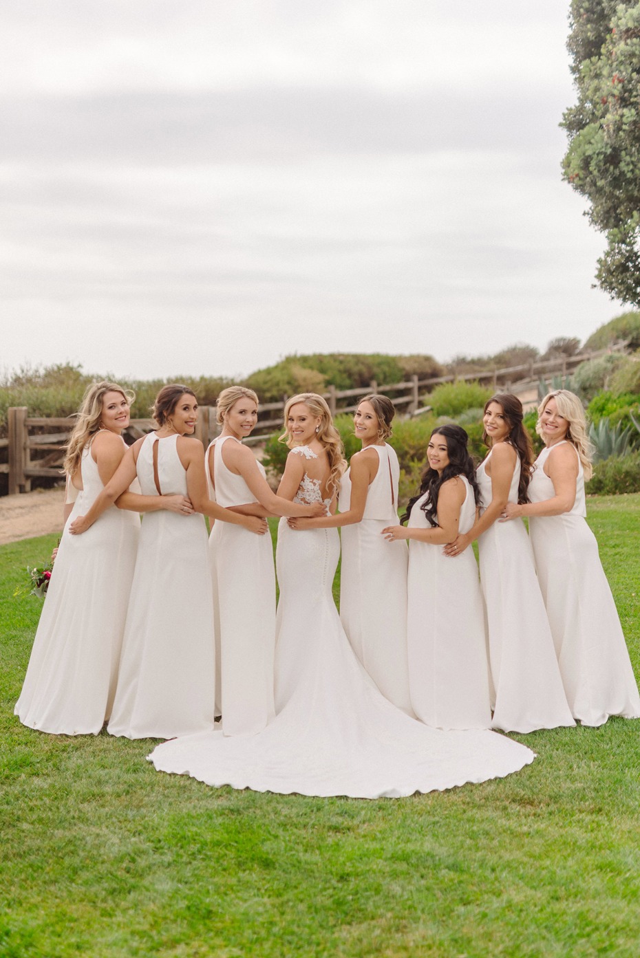 Bride and bridesmaids celebrating wedding day in white dresses