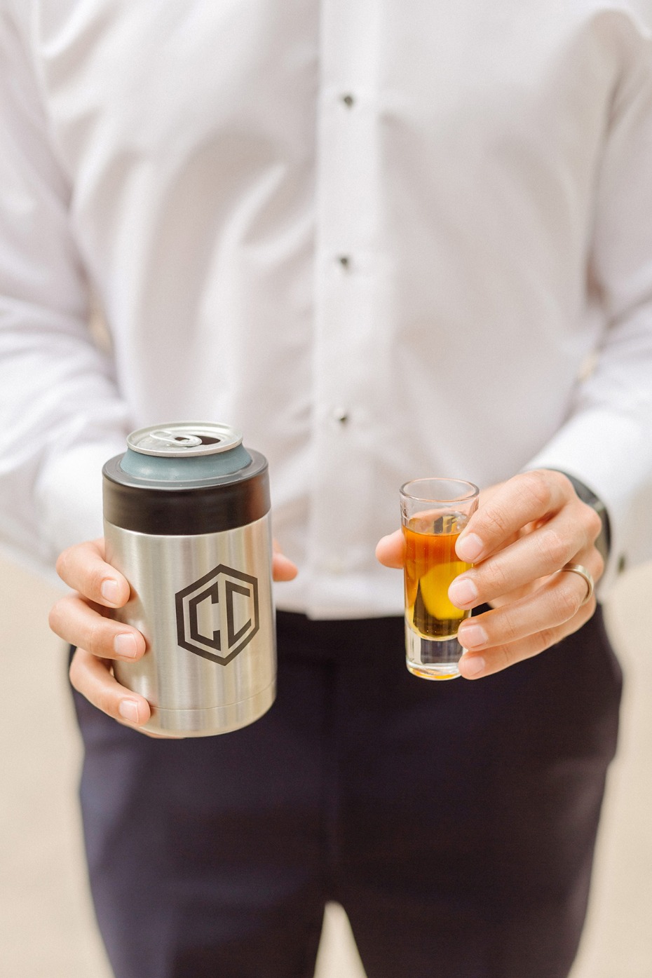 Man holding a shot glass and personalized beverage holder