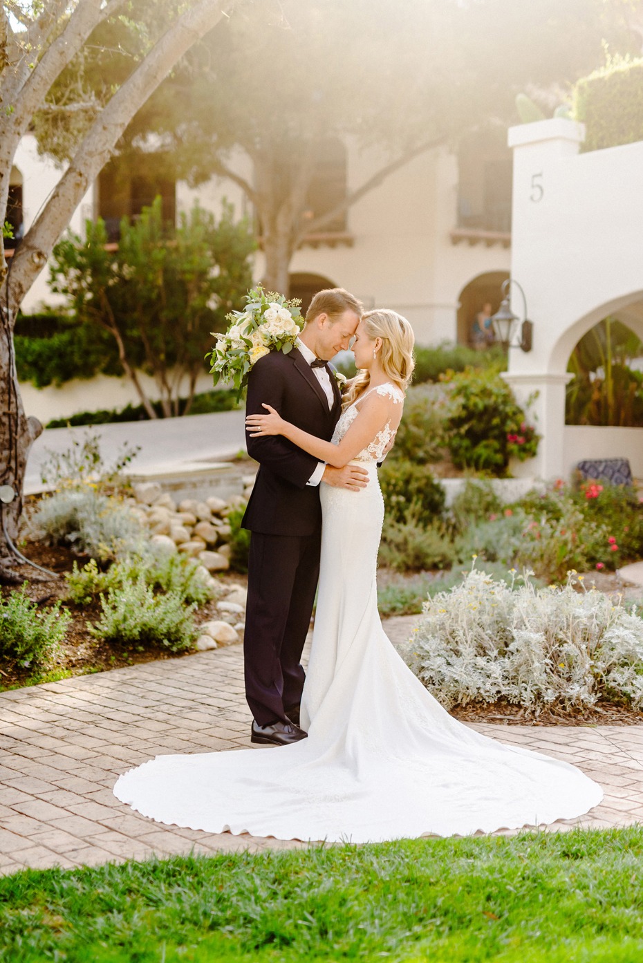 Happy couple embracing in a sunlit wedding portrait photo